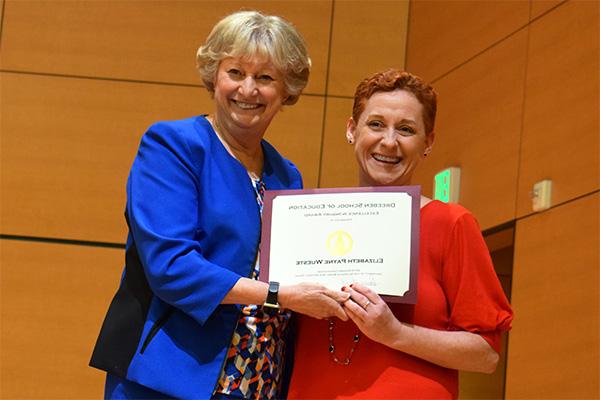 Elizabeth L. Payne and a colleague holding a certificate